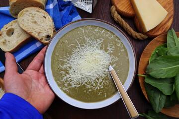 Green spring, summer healthy cream soup of sorrel with parmesan cheese, delicious homemade dinner