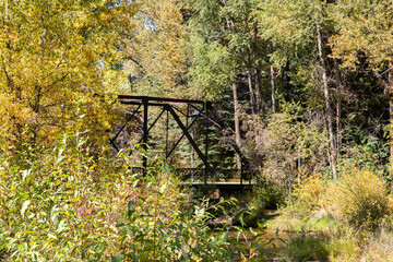 Old bridge spans over small creek in rural Colorado