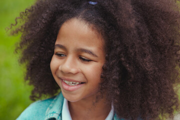 Lovely girl with bright smile and beautiful curly hair