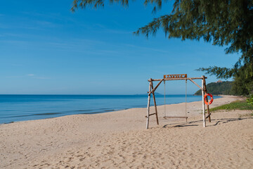 wooden swing on sand beach at Ban Krut beach. travel destination in Prachuap khiri khan, Thailand. summer relax vacation. calm wave sea.