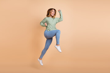 Fototapeta na wymiar Full length body size back view photo woman jumping gesturing like winner overjoyed isolated pastel beige color background
