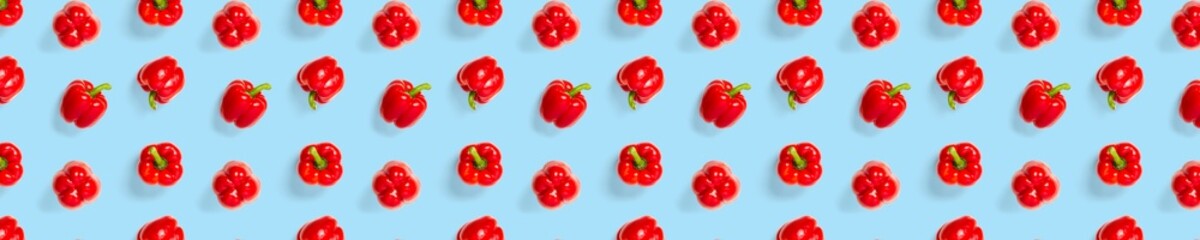 Bulgarian red ripe pepper on blue backdrop. background from paprika, flat lay not seamless pattern