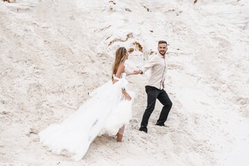Beautiful wedding couple bride and groom at wedding day outdoors at ocean beach. Happy marriage...
