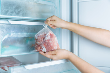 Taking frozen meat from the modern no-frost freezer