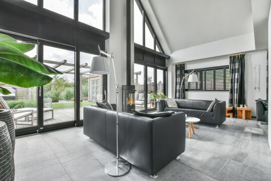 Leathers couches placed near firebox in modern house