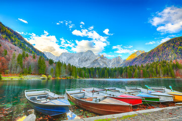 Breathtaking view of sunset over Fusine lake with Mangart peak on background.