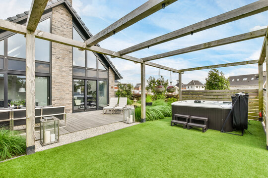 Terrace with chairs and sofa around table