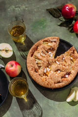 Apple pie. Sponge cake with apples on a green background