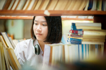 Close up of ัyoung student choosing books at library