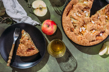 Apple pie. Sponge cake with apples on a green background