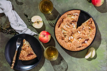 Apple pie. Sponge cake with apples on a green background