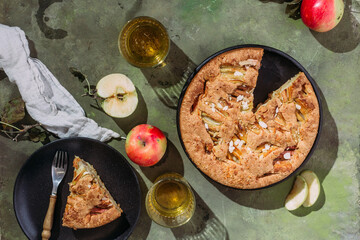 Apple pie. Sponge cake with apples on a green background