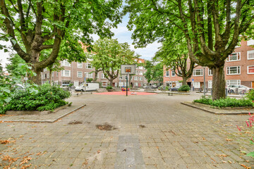 Park with basketball court in city in daytime