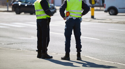 Fototapeta premium Police officer on the street in urban environment.