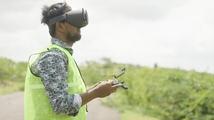 Professional drone pilot controlling drone by looking into virtual reality headset using remote controller - Concept of modern Surveillance technology and inspection. - Powered by Adobe