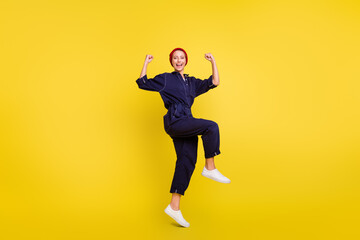 Fototapeta na wymiar Full length body size view of attractive cheerful lucky girl jumping rejoicing isolated over bright yellow color background