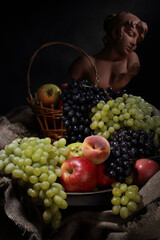 Still life with fruit and antique female bust in retro style