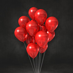 Red balloons bunch on a black wall background