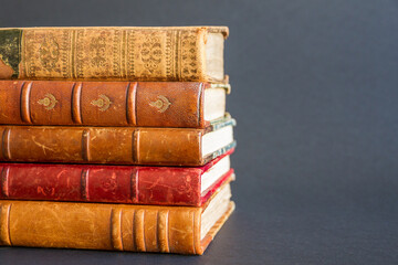 Stack of old books on dark background