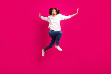 Full body photo of young excited girl amazed shocked surprised jump yell isolated over pink color background