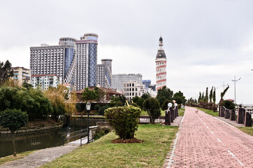 BATUMI, GEORGIA: Scenic street photography of Batumi city center with skyscrapers and old buildings  on summer sunny day with mountains in the background 