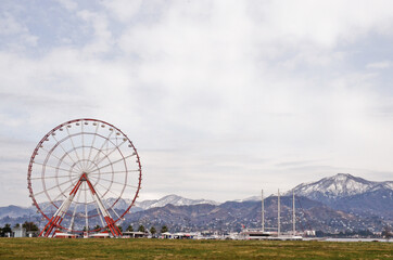 BATUMI, GEORGIA: Scenic street photography of Batumi city center with skyscrapers and old buildings  on summer sunny day with mountains in the background 