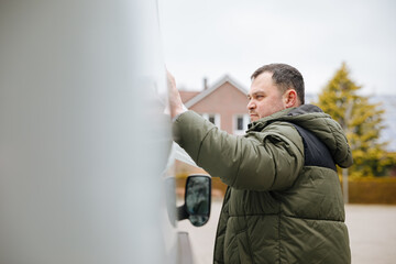 Attach a sticker to a car. You check whether a sticker sticks well to a car. Stick the company logo...