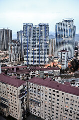 Obraz premium BATUMI, GEORGIA: Scenic street photography of Batumi city center with skyscrapers and old buildings on summer sunny day with mountains in the background 