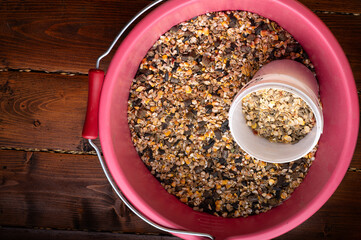 basical muesli and granules for  horses  served in pink bucket. close up . feeding and horse care...