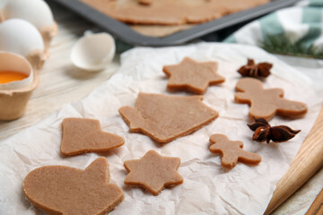 Raw Christmas cookies and anise on table, closeup