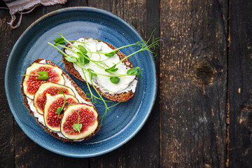 fig sandwich, cream cheese healthy breakfast fresh portion ready to eat meal snack on the table copy space food background rustic. top view keto or paleo diet veggie vegan or vegetarian food