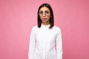 Photo shot of beautiful sorrowful young brunette woman wearing casual clothes and stylish optical...