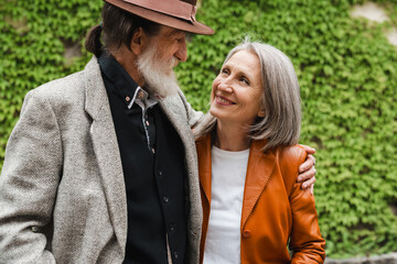 Fototapeta premium White senior couple hugging and smiling to each other