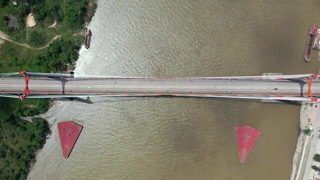 Aerial drone vertical view of vehicles crossing Zarate bridge, in Argentina. Paran&aacute; river between the province of Buenos Aires and Entre rios.