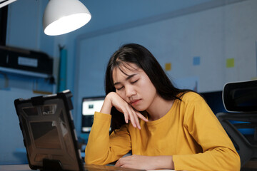 Young woman working on laptop in the office.