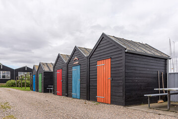 Fototapeta na wymiar fishermens shacks lined up with doors in bright colours