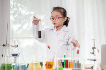 scientist girl with liquid solution in a laboratory