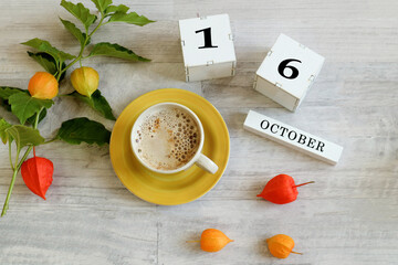 Calendar for October 16 : the name of the month in English, cubes with the number 16, a yellow cup...