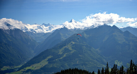 Mountain range High Tauern with red paraglider
