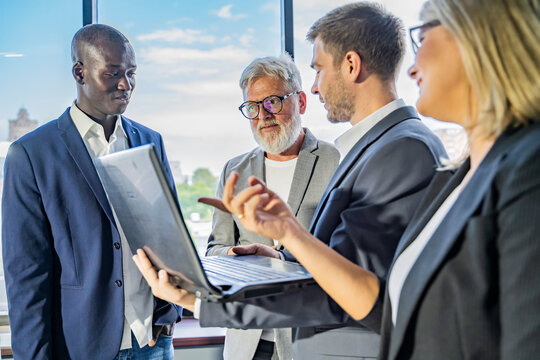 Four diverse business workgroup team with african man leader discuss paperwork financial report statistical data, Brainstorm, briefing activity concept