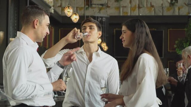 Group of corporate people drinking champagne and discussing at the company party. business meeting conference or  New Year party. colleagues enjoy talking together
