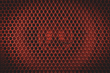 Red orange stylish car audio acoustic round speaker with waffle grill protector cover closeup....