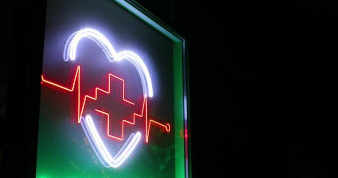 Pharmacy symbol green and red light, neon flashing cross light, glowing heart, pharmacy signboard.