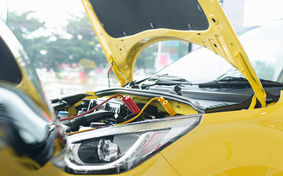 New Car Battery To Start The Engine Of The Vehicle Using Cables,Trying To Jump Start A Car's.safely Jump Start A Dead Battery Concept.