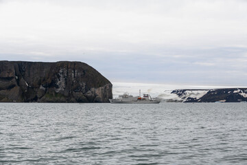 Expedition ship in Arctic sea with ice. White research vessel.  in Tikhaya Bay (Tikhaya Bukhta) on...