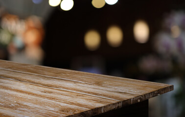 Empty wooden table in front of abstract blurred background of coffee shop . can be used for display or montage your products.Mock up for display of product