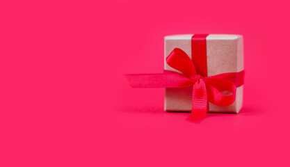 Christmas gift box with ribbon bow on red background background