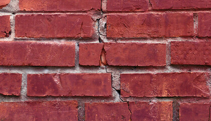 Crack in red old brick wall