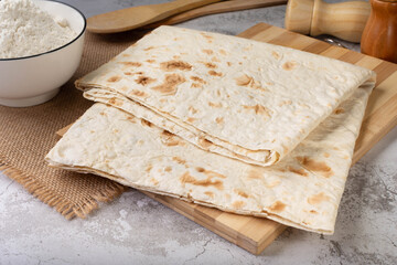 Pita bread sheets.Lavash. Pita bread sheets on a wooden board
