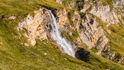 Beautiful alpine summer view with a waterfall in HDR at the famous Grossglockner high Alpine road, Salzburg, Austria
